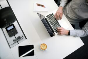 a man is sitting in the front of laptops